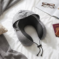 Grey travel pillow with hood to block light while sleeping